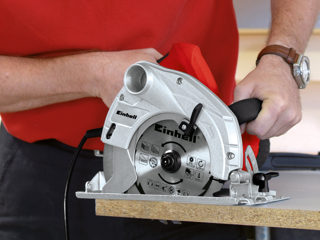 a man cuts a wooden board with a hand circular saw