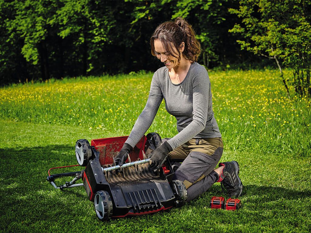 A woman looks at the scarifier from below