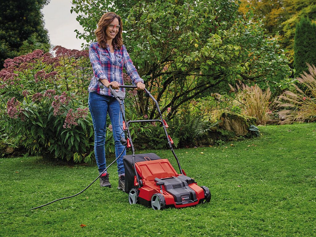 a woman scarifies the lawn