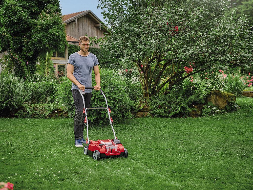 a man scarifies the lawn