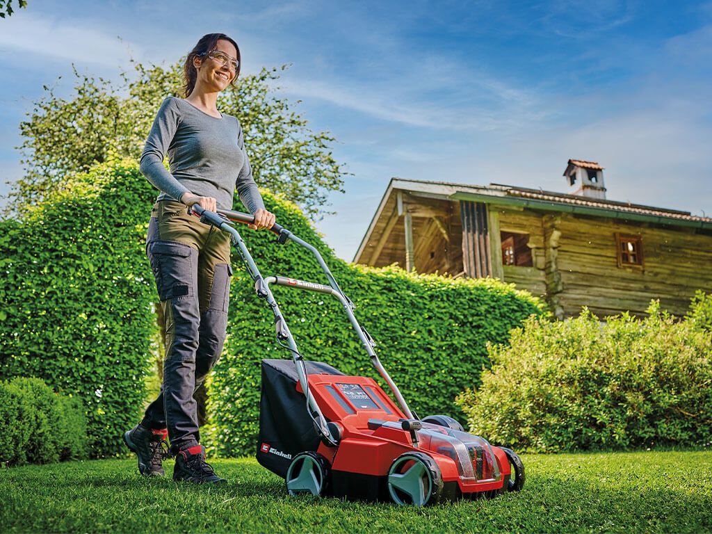 a woman scarifies her lawn