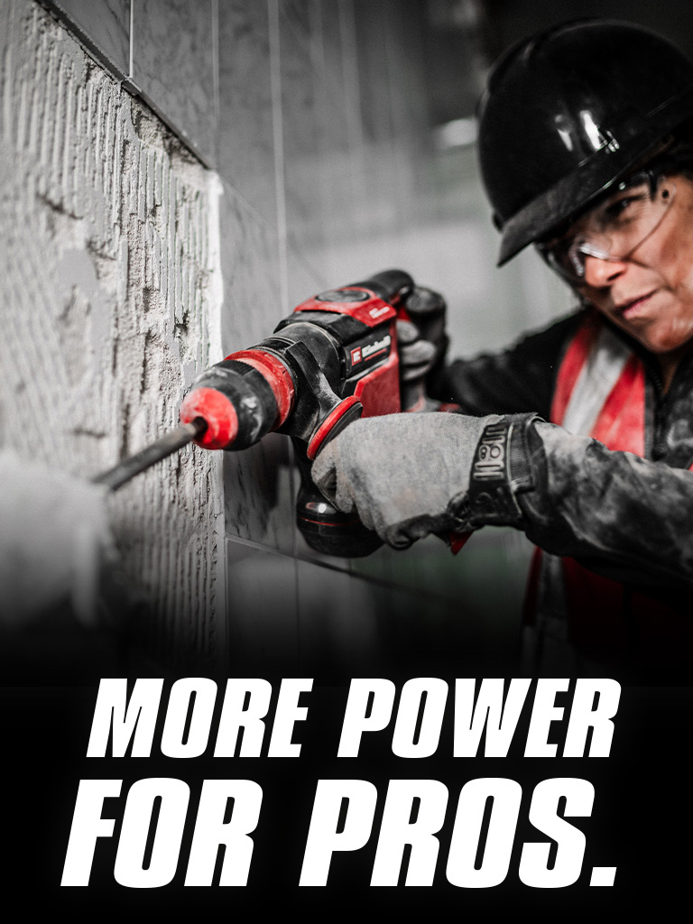 A person wearing safety glasses and a helmet uses a red drill on a wall, with the text "More Power for Pros".