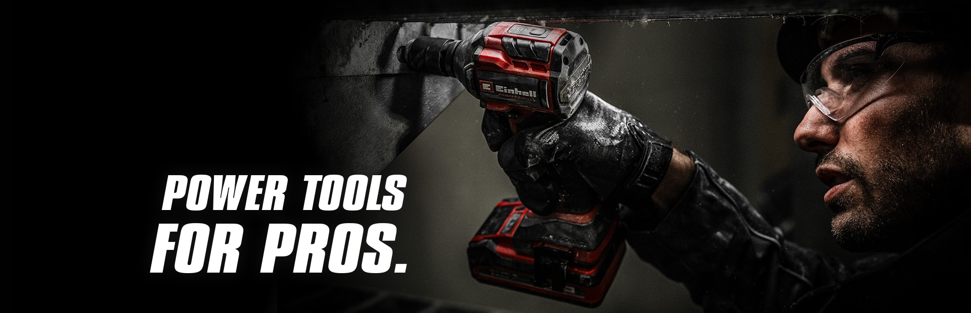 A hand holds a red cordless impact wrench being used on a metal beam, with the text "Power Tools for Pros".