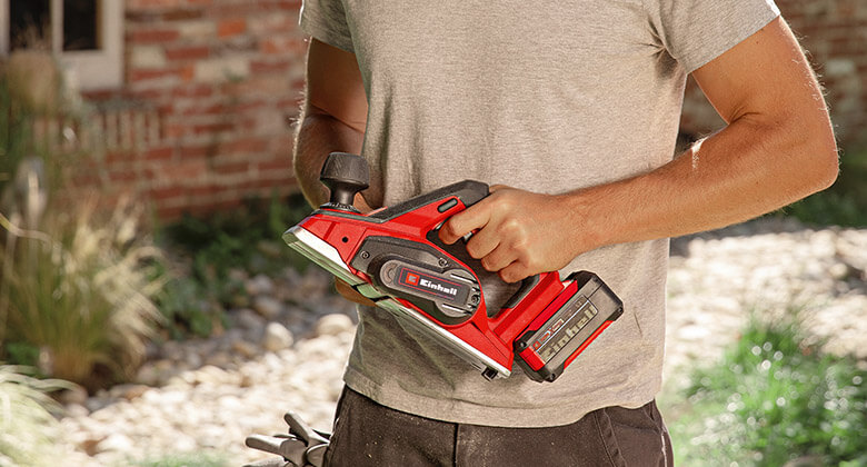 man holding an electric planer